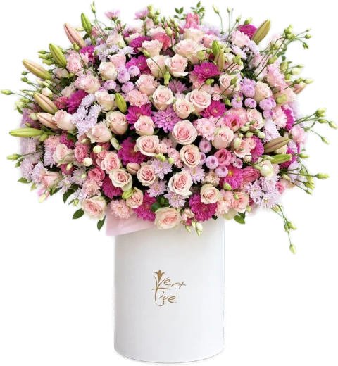 Pink roses, lilies and pink and purple flowers in a tall white Vert Tige box